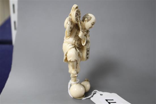 A Japanese carved ivory figure of an entertainer startled by a rat, late Meiji period, signed, height 11.5cm